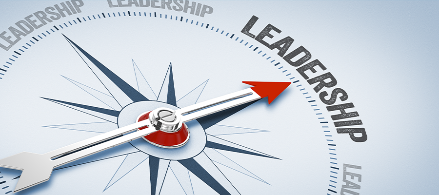 A compass with a red arrow pointing toward the word “Leadership,” symbolizing direction, guidance, and effective leadership. The word “Leadership” appears multiple times around the compass, emphasizing focus and purpose in leadership.